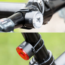 Ledsavers Cykellygter hvid forlygte og rød baglygte med sorte gummistropper, batteridrevne.