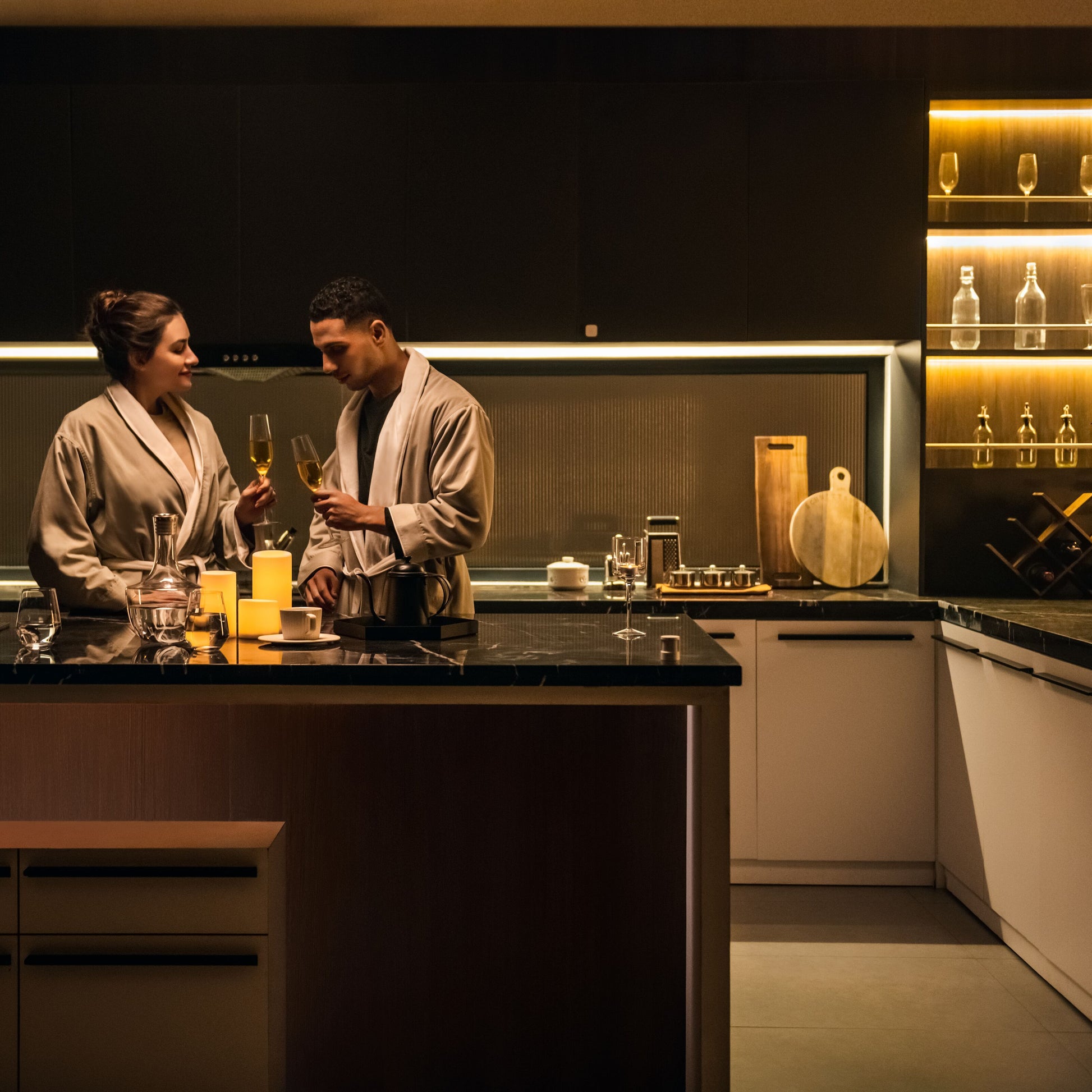 Aqara LED-strips T1 2 m opsat under køkkenskabe i moderne køkken med glas og levende lys, varm belysning.