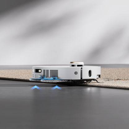 Dreame X40 Ultra fuldautomatisk støvsugerrobot skifter fra hårdt gulv til tæppe og lyser blåt under rengøring.