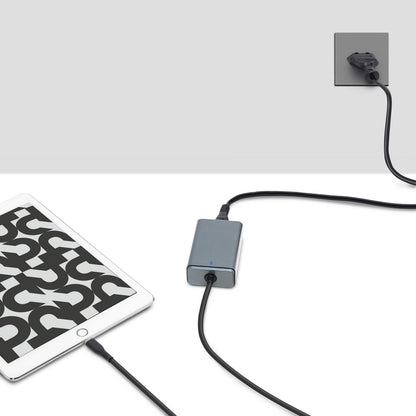 Tablet tilsluttet med sort kabel til Plexgear kompakt USB-C Computer oplader 65 W i stikkontakt, oplades.
