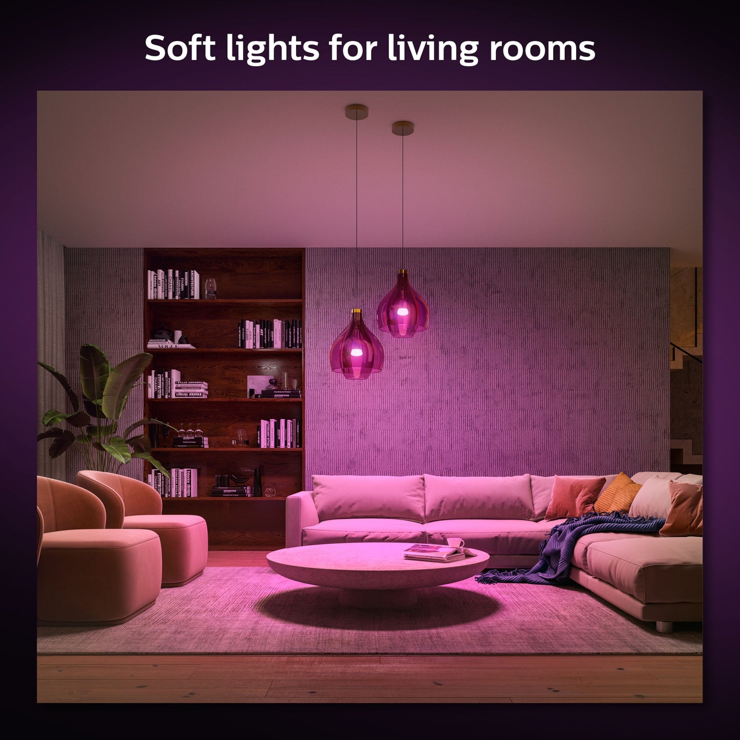 Philips Hue Color Ambiance Smart LED-pære E27 1100 lm 2-pak lyser stue op med varm pink, beige sofa, runde borde, reol.