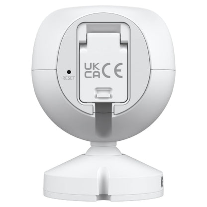Ubiquiti G4 Instant overvågningskamera hvid set bagfra med cirkulær fod, RESET-knap og UK CA/CE mærker på midten.