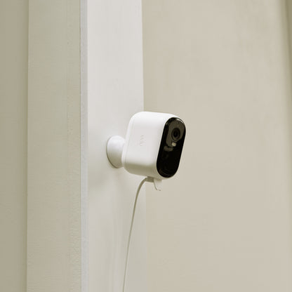 Arlo sikkerhedskamera hvid/sort front, monteret på væg med Arlo Essential 2 udendørskabel synligt nedenunder.