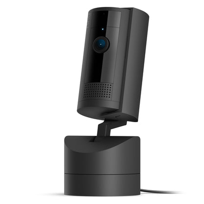 Ring Pan-Tilt indendørs kamera sort, cylinder på rektangulær base, 1080p HD linse, 360° panorering, statuslys, kabel synligt.
