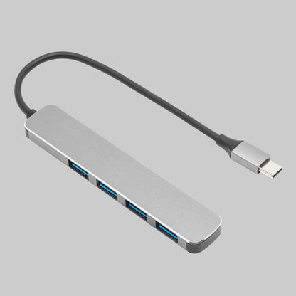 CB223 USB-A-hub med USB-C, 4 porte, slankt gråt metalkabinet, kort sort kabel med USB-C-stik.