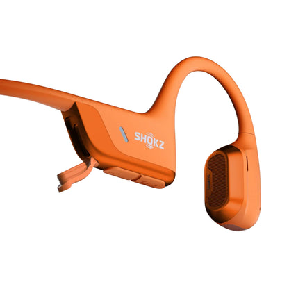 Shokz OpenRun Pro 2 Mini trådløse hovedtelefoner orange med Shokz-logo, ørekrog og synlige kontrolknapper.