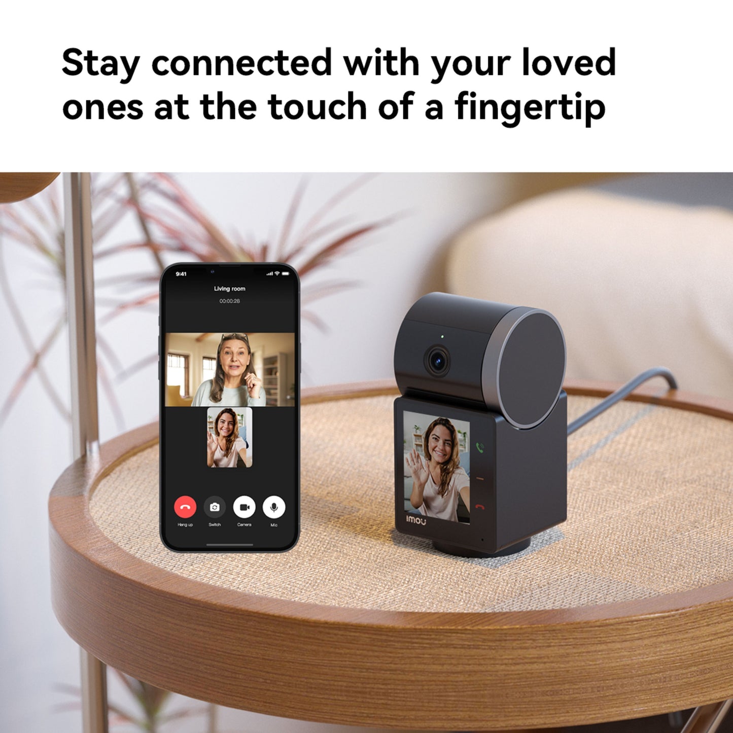 Imou Rex VT Pro 5 MP Trådløs indendørskamera ved siden af smartphone med videoopkald, Imou-logo synligt.