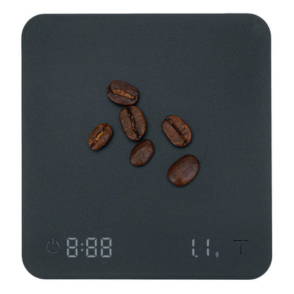 Wilfa Uni Mini kaffevægt mørk overflade, display viser 1,1 gram kaffe, strøm- og tare-knapper nederst.