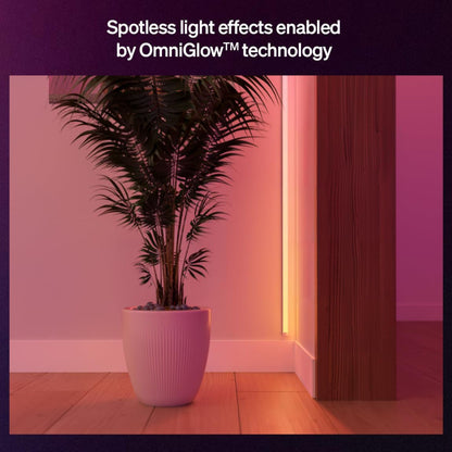 Philips Hue OmniGlow smart lysliste dæmpbar, fuld farveskala, vises med pink og orange lys ved væg og gulv.