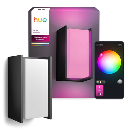Philips Hue Turaco udendørs væglampe med emballage, lyser pink, smartphone viser farvehjul til lysstyring.