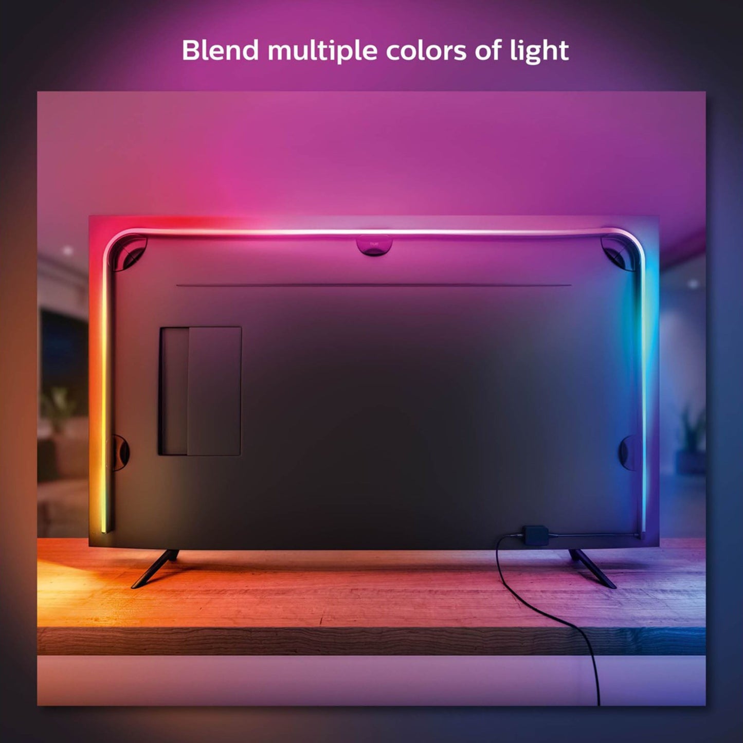 Philips Hue Play Gradient Lightstrip TV 75", lys i pink, blå, orange, gul langs kanter, tekst på skærm: Bland flere farver.