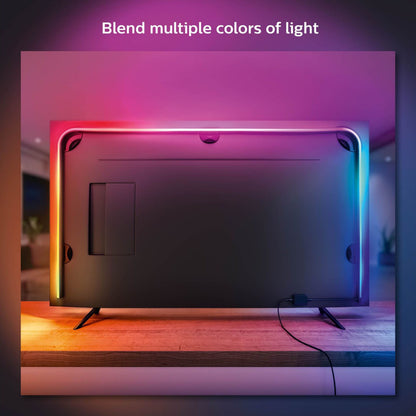 Philips Hue Play Gradient Lightstrip TV 75", lys i pink, blå, orange, gul langs kanter, tekst på skærm: Bland flere farver.
