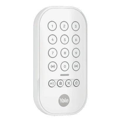 Yale alarmknap sæt, hvidt vægmonteret nøglepanel med numerisk tastatur 0-9, brandfunktionsknapper, Yale-logo nederst.