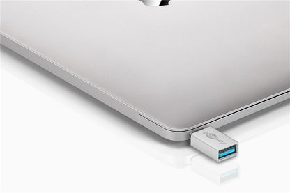 Goobay USB-C til USB-A OTG-adapter med blåt indre og Goobay-logo, tilsluttet sølvfarvet laptop.