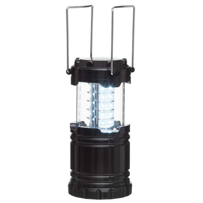 LED campinglanterne i sort cylinderform med to metalhåndtag, klar midte udsender hvidt lys ved udfoldning.