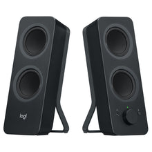 Logitech Z207 Bluetooth-computerhøjttalere, to sorte højttalere med dobbelte drivere, lydstyrkeknap og hovedtelefonstik.