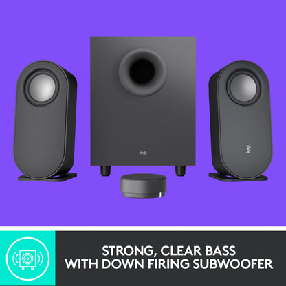 Logitech Z407 højttalersystem med to ovale højttalere, en firkantet subwoofer og en trådløs fjernbetjening ved bas-teksten.