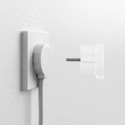 NORM stikprop Schuko, hvid, delvist transparent, tæt ved stikkontakt med tilsluttet kabel.