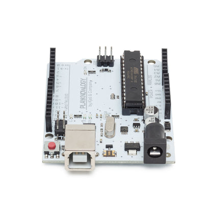Arduino Uno Rev. 3 kompatibelt udviklingskort, hvidt, USB Type-B, sorte pin-headers, ATmega328-chip, strømstik, frontvinkel.