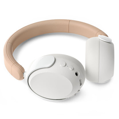 Philips trådløse over-ear hovedtelefoner til børn, beige bøjle, hvide ørekopper, støjreduktion, lydbegrænsning, knapper/porte højre.