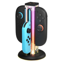 Zeus-ladestation til Nintendo Switch/Switch 2 til tre Joy-Con, inkl. en blå, flerfarvet LED-lampe i en gennemsigtig søjle.