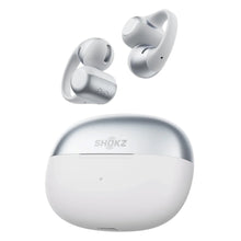 Shokz OpenDots 2 åbne clip-on-høretelefoner i gråt med ørekroge, leveres med et rundt, gråt opladningsetui, DirectPitch-teknologi.