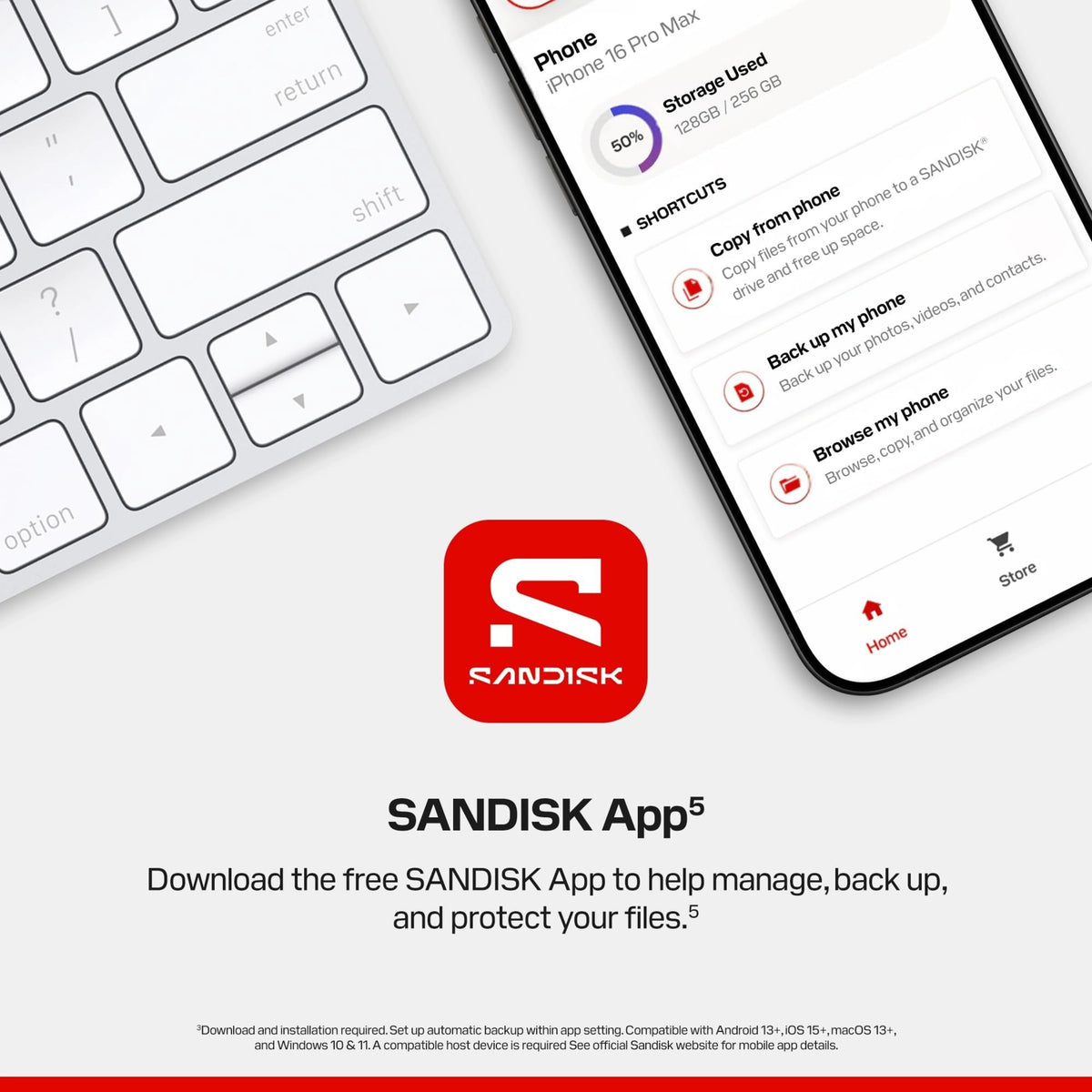 SanDisk bærbar SSD 1 TB, USB-C, 600 MB/s, set via smartphone-app ved siden af tastaturet med logo.