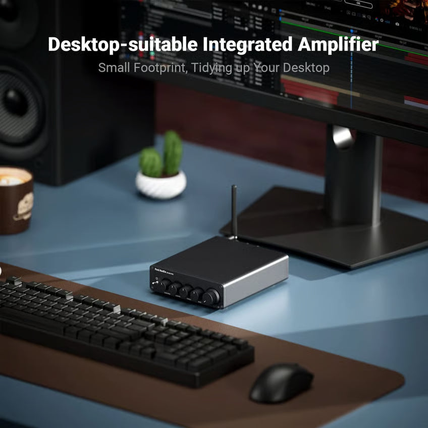 Fosi Audio BT30D Pro 2.1-forstærker, Bluetooth, 48 V, fire drejeknapper og antenne på skrivebordet foran computerskærmen.