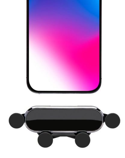 Mobilholder med quick release til ventilatorgitter, sort og krom, gummigreb, vist under smartphone med farvegradient-baggrund.